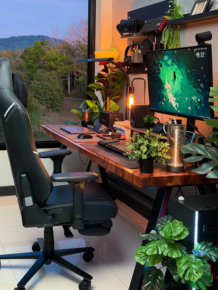 Handsome home office featuring warm cognac leather armchair, matte black wall accents, and warm wooden desk accessories
