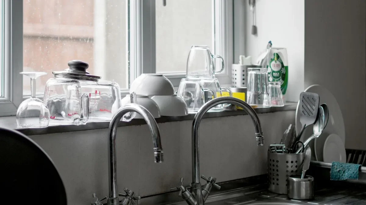 High-arc laundry faucet clearance over a deep utility sink with aerated water stream