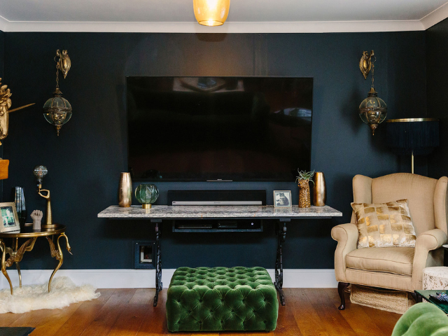 A TV Mounted in a Dedicated Recessed Nook Painted in a Dark, Matching Tone