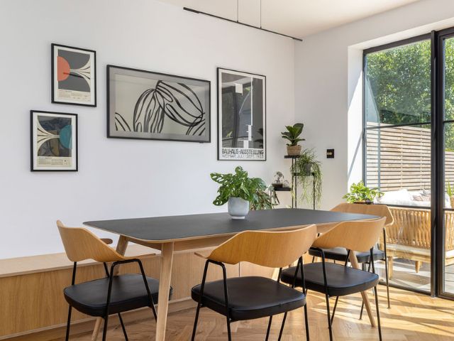 A Gallery Wall Layout With the TV Blended in Among Frames